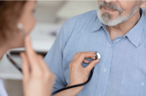 cardiologist using stethoscope checking heartbeat